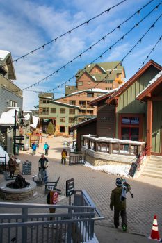 a community square with a fire pit at the Winter Park Resort