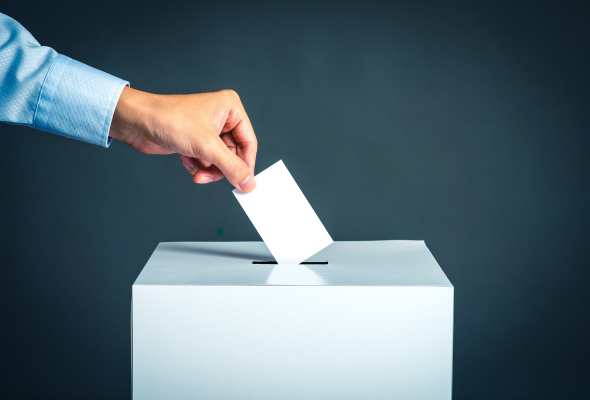Person putting a vote in a voting box